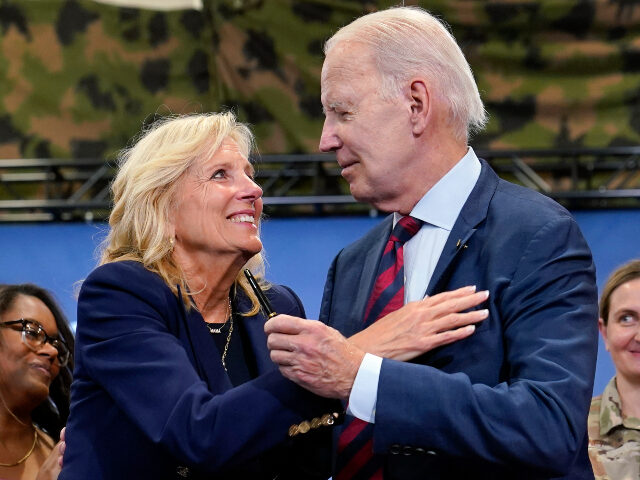 AP24108515181523 FILE - First lady Jill Biden looks at President Joe Biden as he holds the pen he used to s