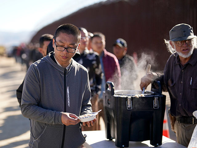 ap24130577305320-640x480-1 A man from China gets a bowl of oatmeal from a volunteer as he waits with others for proce