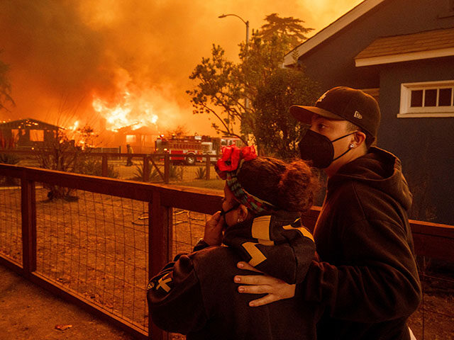 People watch as the Eaton Fire destroys a neigborhood Wednesday, Jan. 8, 2025 in Altadena, Calif. (AP Photo/Ethan Swope) L.A. - People watch as the Eaton Fire destroys a neigborhood Wednesday, Jan. 8, 2025 in Al