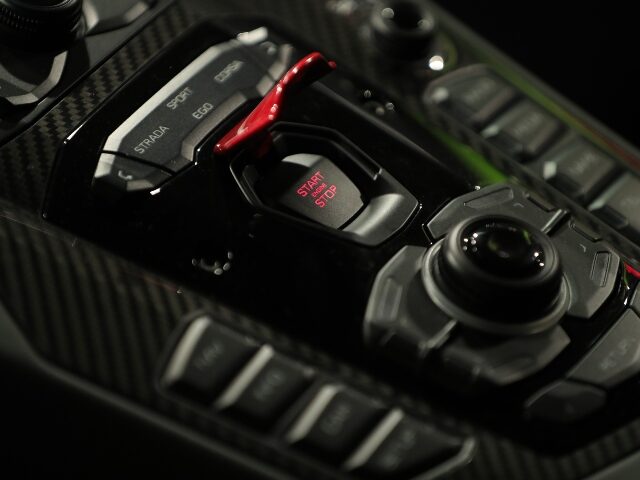 An engine start/stop button sits on a control panel inside a Lamborghini Aventador SVJ lux