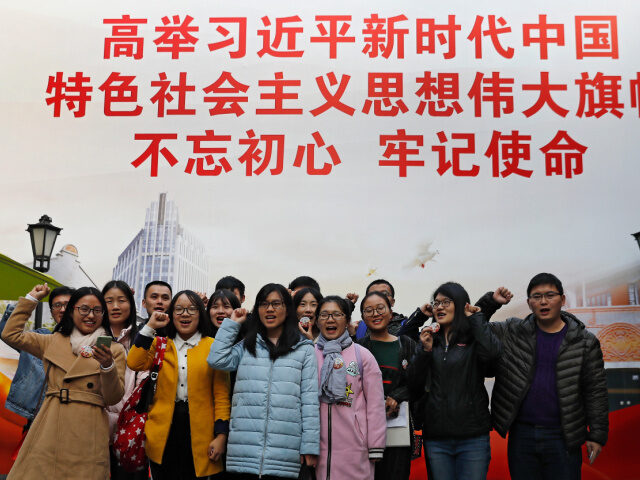 Chinese Students, CCP In this Nov. 19, 2017, photo, a group of university students raise their fists to take the