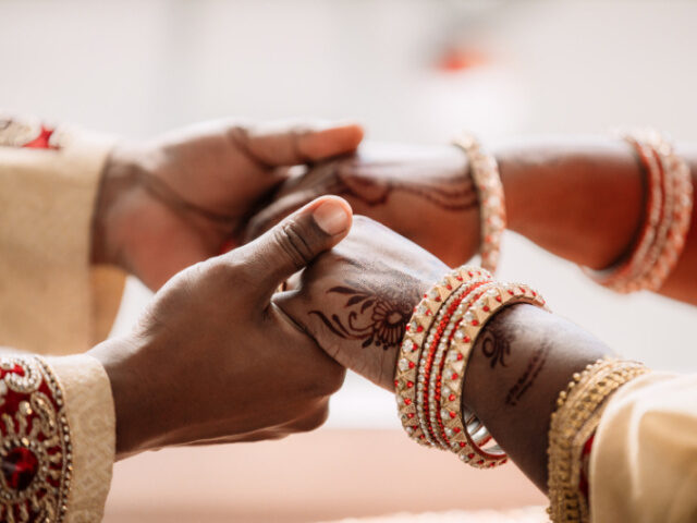 Couple Getting Married Cropped shot of an unrecognizable young couple holding hands on their wedding day. Marco V