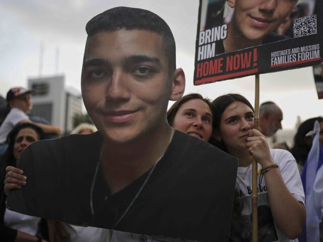 Edan Alexander 2 (Oded Balilty / Associated Press) People watch a live broadcast of Israeli-American soldier Edan Alexander as he is released