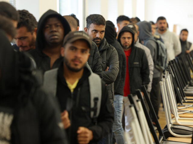 gettyimages-1718519368-1-640x480-1 EISENHUETTENSTADT, GERMANY - OCTOBER 05: Men, many of them from Syria, queue for lunch at