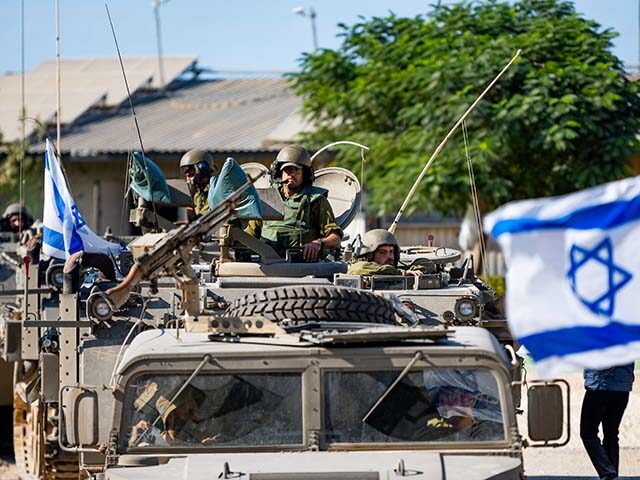 gettyimages-1741519506-640x480-1 IDF Soldiers ride in armored personnel carriers on October 17, 2023 in Be'eri, Israel