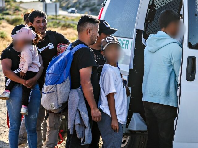 Migrant gather in camps near the US/Mexico border. Jacumba Hot Springs, CA, Sunday, May 12, 2024 - Families board a Border Patrol vehicle at