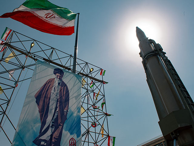 gettyimages-2174079442-640x480-1 A big banner depicting Iran's Supreme Leader Ayatollah Ali Khamenei is placed next to a ba