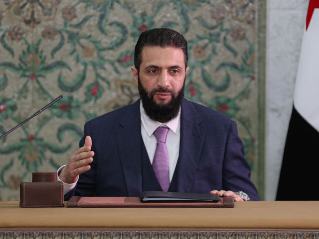 GettyImages-2204252227 DAMASCUS, SYRIA - MARCH 13: Syrian President Ahmed al-Sharaa signs a declaration outlining