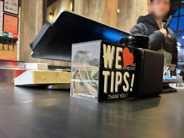 GettyImages-2205584387 We appreciate Tips, Thank you, tips jar in Mighty Quinns BBQ restaurant, Queens, New York.
