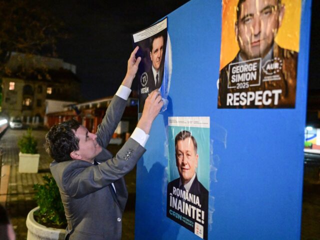 gettyimages-2207741404-1-640x480-1 Mayor of Bucharest and presidential candidate Nicusor Dan pastes a campaign poster of hims