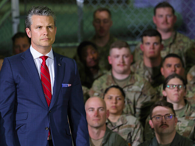 gettyimages-2212639552-640x480-1 Defense Secretary Pete Hegseth listens as President Donald Trump speaks during a visit wit