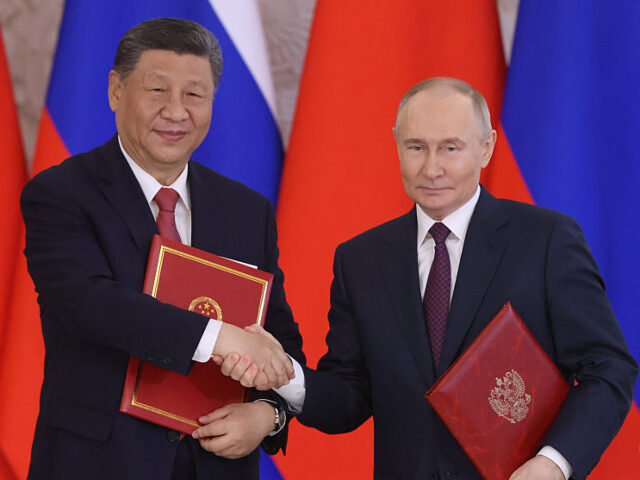 GettyImages-2213387819 MOSCOW, RUSSIA - MAY 8 (RUSSIA OUT) Russian President Vladimir Putin (R) exchanges documen
