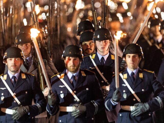 gettyimages-2213593975-1-640x480-1 BERLIN, GERMANY - MAY 05: Soldiers from the guard battalion stand with torches during tatt