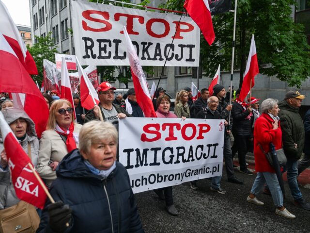 gettyimages-2214343276-1-640x480-1 WARSAW, POLAND - MAY 10: People hold banners and the Polish national flag during an anti i