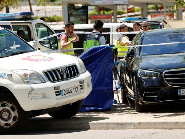 SPAIN-UKRAINE-RUSSIA-POLITICS-HOMICIDE Police officers work near the body (behind blue curtain) of late ex-Ukraine MP Andrey (And