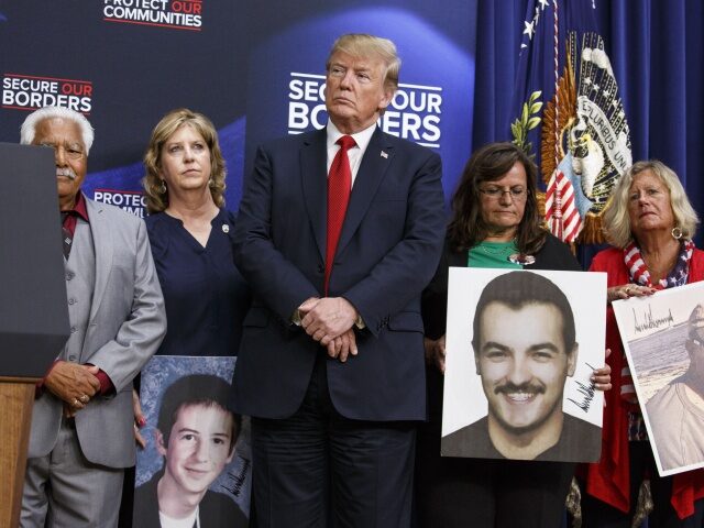 President Trump Speaks On Immigration With 'Angel Families' U.S. President Donald Trump stands with families who have lost relatives to crimes caused