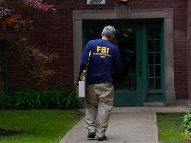 Home Listed for Elias Rodriguez, FBI An official works at the scene of an address listed in public records as the home of Elias