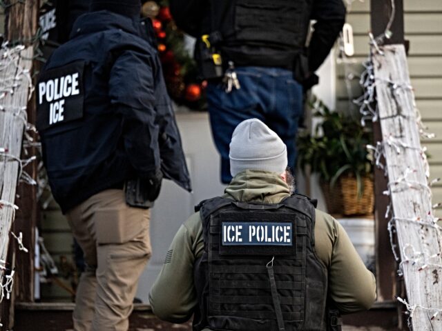 ice migrant raid US Immigration and Customs Enforcement (ICE) agents knock on the door of a residence durin