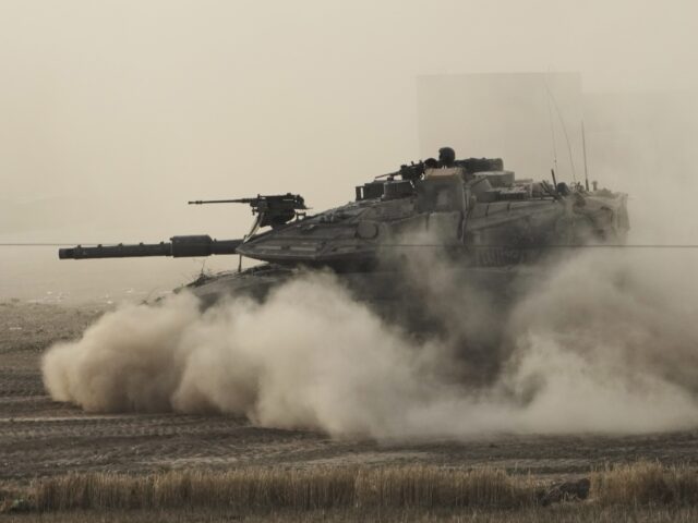 IDF tank (Maya Alleruzzo / Associated Press) An Israeli tank moves in a staging area in southern Israel, near the border with Gaza, Fri