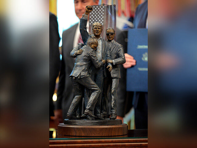 imgonline-com-ua-frameblurred-w1f1a850mg-640x480-1 A statue of U.S. President Donald Trump modeled after the 2024 attempted assassination on
