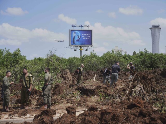 Israel Ben Gurion (Ohad Zwigenberg / Associated Press) Israeli security forces inspect the site where the Israeli military said a projectile fire