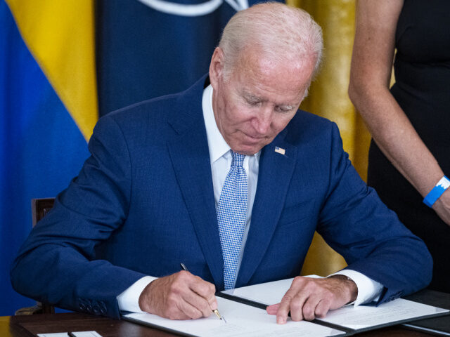 Joe Biden Signs a Document US President Joe Biden signs the Instruments of Ratification for the Accession Protocols t