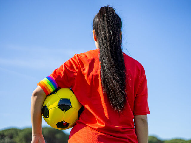 LGBTQ-pride-flag-soccer-ball-stock-getty LGBT pride flag on the field. LGBTQ people in sport. - stock photo