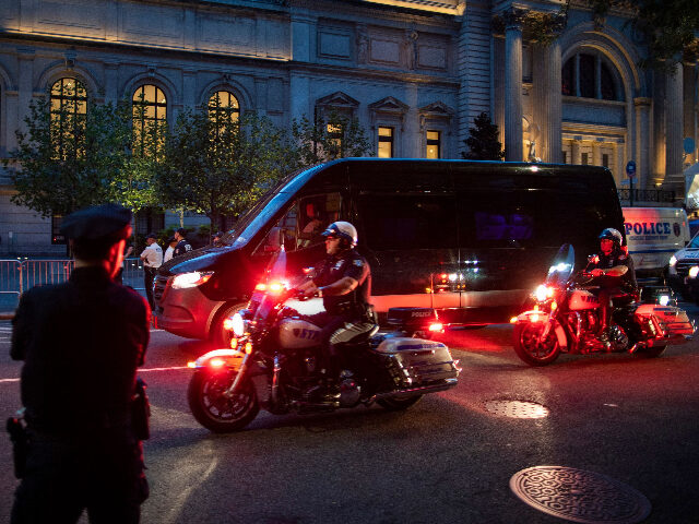 metgalaprotest NYPD officer patrol a street after arresting some protesters during a "Defund the Pol
