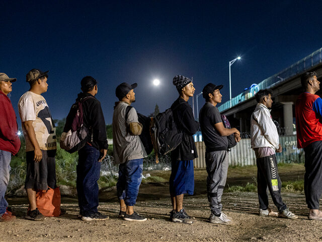 migrants-line-us-mexico-border-file23-getty EAGLE PASS, TEXAS - SEPTEMBER 29: Under a full moon Venezuelan immigrants stand in line to