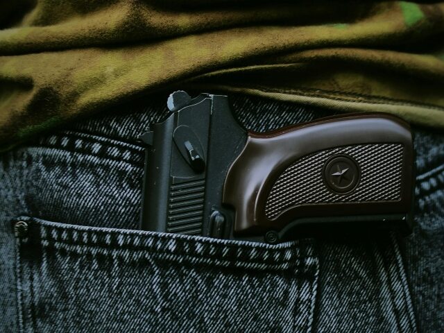 pexels-darya-grey_owl-132130036-16778234 close up of gun in jeans pocket