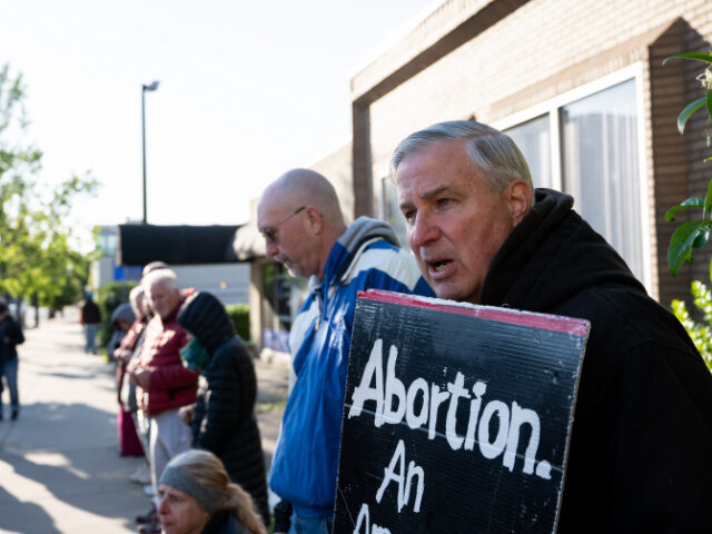 Pro-Life Protesters at Clinic A pro-life demonstrator stands in front of EMW Women's Surgical Center, an abortion c