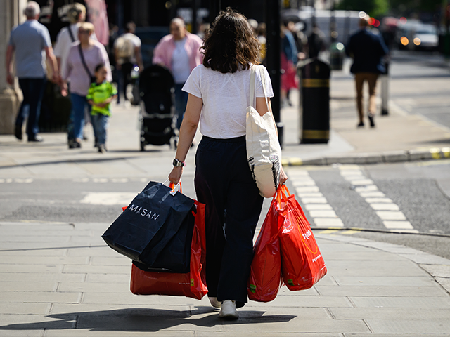 shopper-consumers-getty LONDON, ENGLAND - MAY 10: A shopper carries bags through the Oxford Street financial distr