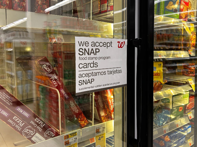 SNAP food stamps Bilingual sign on door of frozen food aisle, We accept SNAP food stamp cards, Walgreens, Q