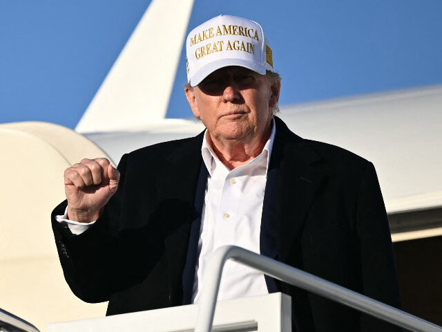 trumphollywood US President Donald Trump raises a fist as he steps off Air Force One upon arrival at Join