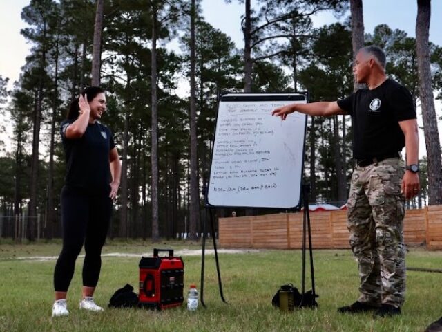 UTF-8Photo 1 Tulsi Gabbard participates in a workout at Camp MacKall with a training group of Special F