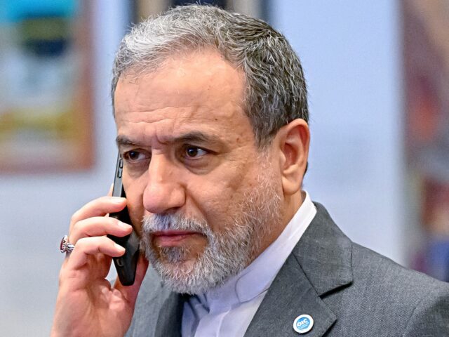 Abbas Araghchi Iran's Foreign Minister ran foreign minister Abbas Araghchi talks on his mobile phone ahead the family photo durin