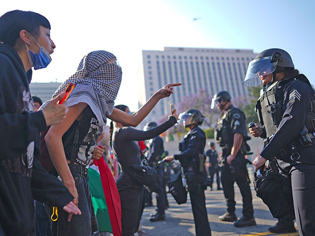 ap25161065369571 Protesters confront Los Angeles police department personnel in riot gear in downtown Los Angeles on Monday, June 9, 2025. (AP Photo/Eric Thayer)