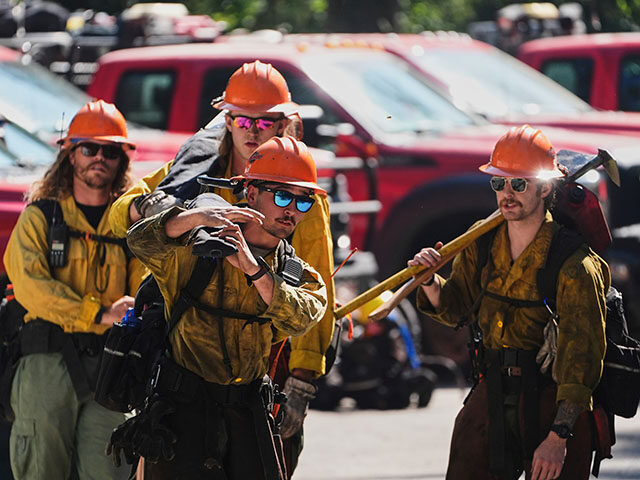 ap25181661783575-640x480-1 Wildland firefighters with the United States Forest Service prepare at a staging area near