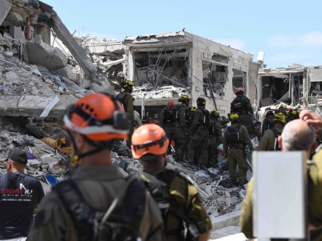 Bat Yam damage (Gili Yaari/NurPhoto via Getty) Rescue teams inspect a damaged building following a strike by an Iranian ballistic missile