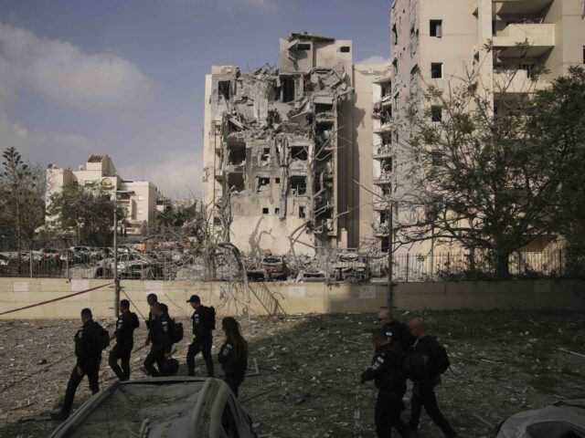 Beer Sheva Iran missile (Leo Correa / Associated Press) Police officers inspect residential buildings destroyed by an Iranian missile strike that