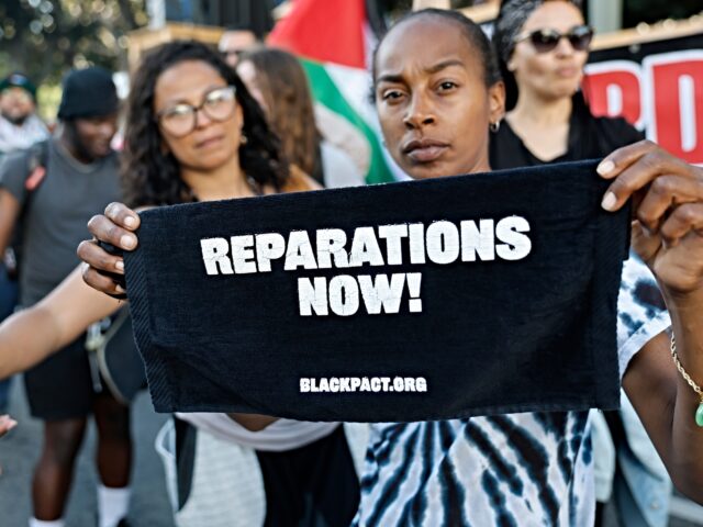BLM reparations call LOS ANGELES, CALIFORNIA - MAY 21: A protestor displays sign reading "Reparations Now!" dur