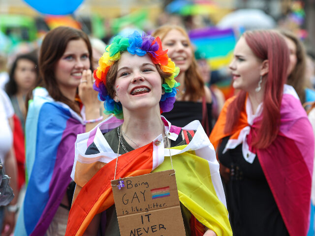 children pride Girl in a rainbow wreath dances as she takes part in the Pride parade. Helsinki Pride Week