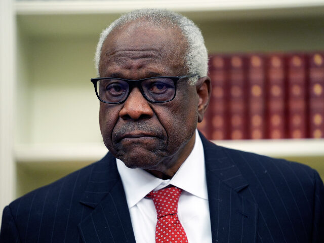 Supreme Court Associate Justice Clarence Thomas listens to President Donald Trump speak be