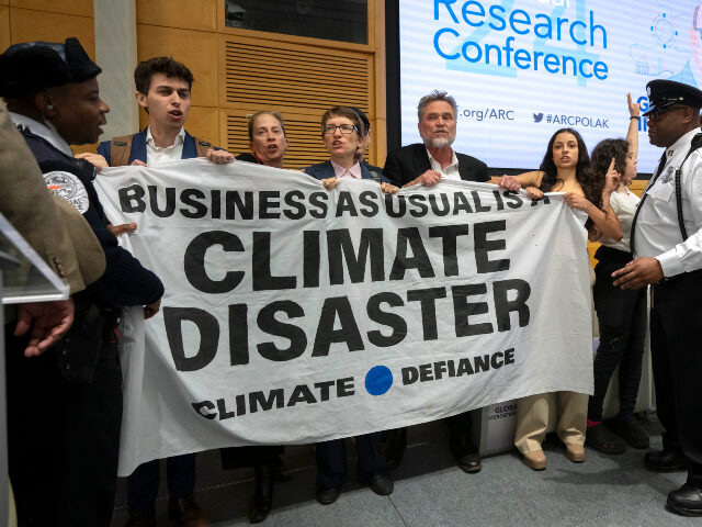 Climate protesters Climate protestors stand on stage after interrupting a speech by Federal Reserve Chairman