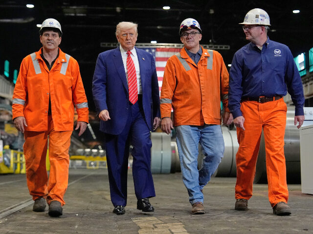 Donald Trump with steel workers President Donald Trump walks with workers as he tours U.S. Steel Corporation's Mon Va