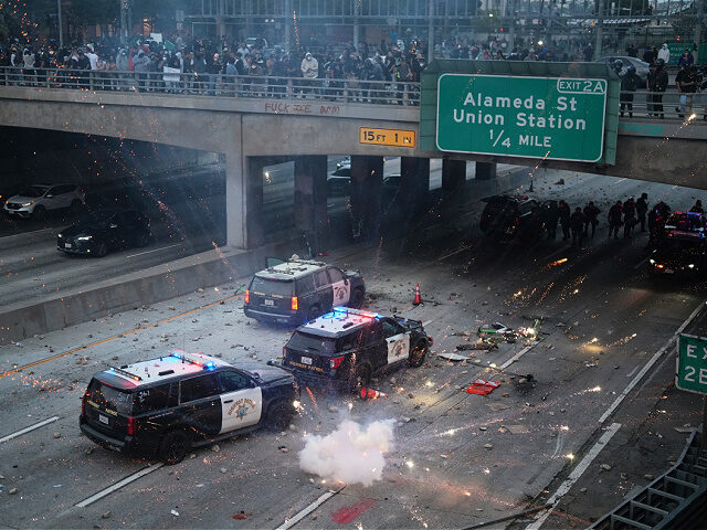 flash-bomb-101-Freeway-Los-Angeles-June-8-2025-ap EDS NOTE: OBSCENITY A flash bomb explodes on the 101 Freeway near the metropolitan detenti