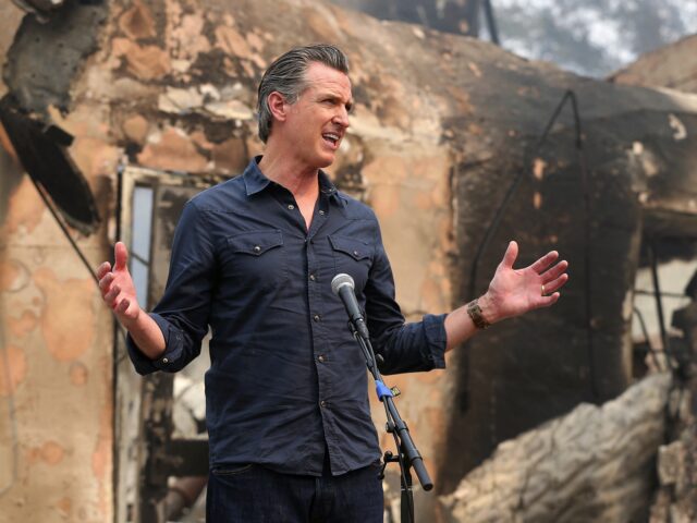 California Governor Gavin Newsom speaks at a press conference while touring areas damaged