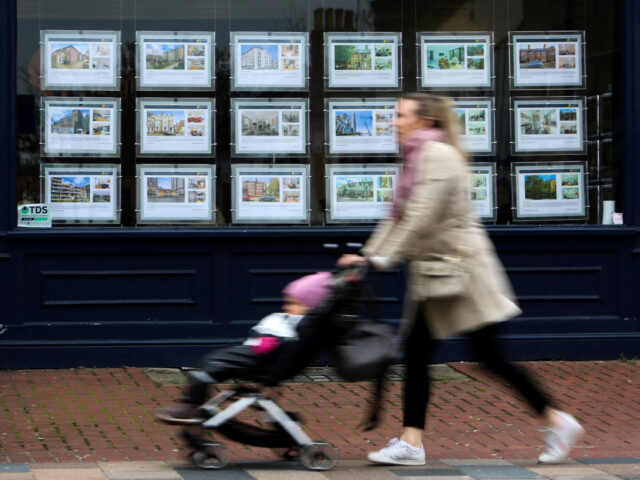 gettyimages-1250338253-1-640x480-1 Pedestrians walk past the front window of an estate agent advertising properties to let an