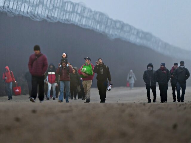 Migrants At The US-Mexico Border JACUMBA HOT SPRINGS, CALIFORNIA - DECEMBER 22: Migrants walk along the US-Mexico border fe