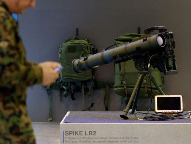 SWITZERLAND-POLITICS-ARMY-ARMAMENT A member of the Swiss army walks past a Spike LR2 Long-Range Missile during a presentation